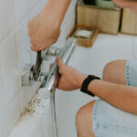 man-installs-a-faucet-in-the-bathroom