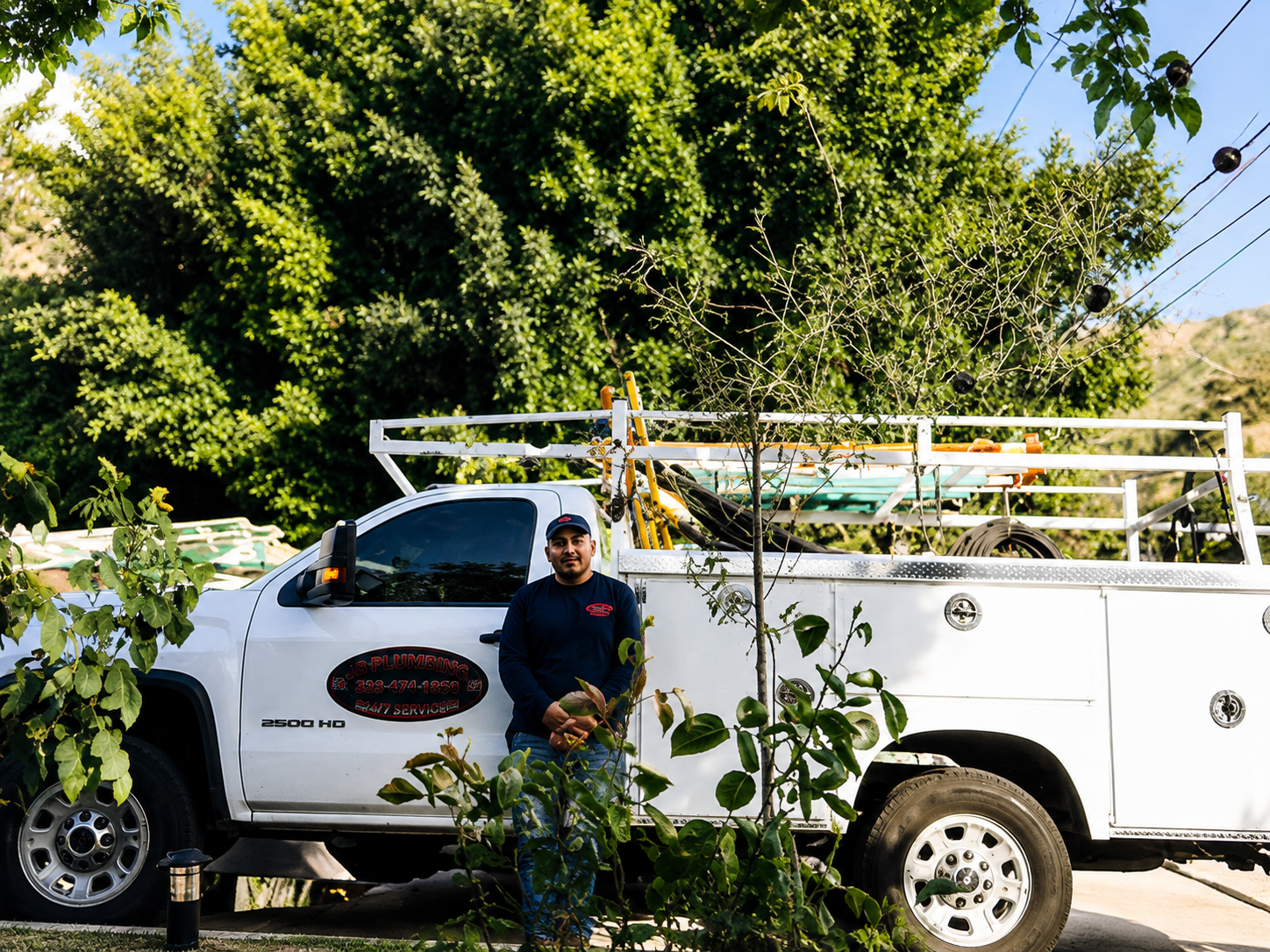 JB Plumbing and Rooter service truck parked in front of a home